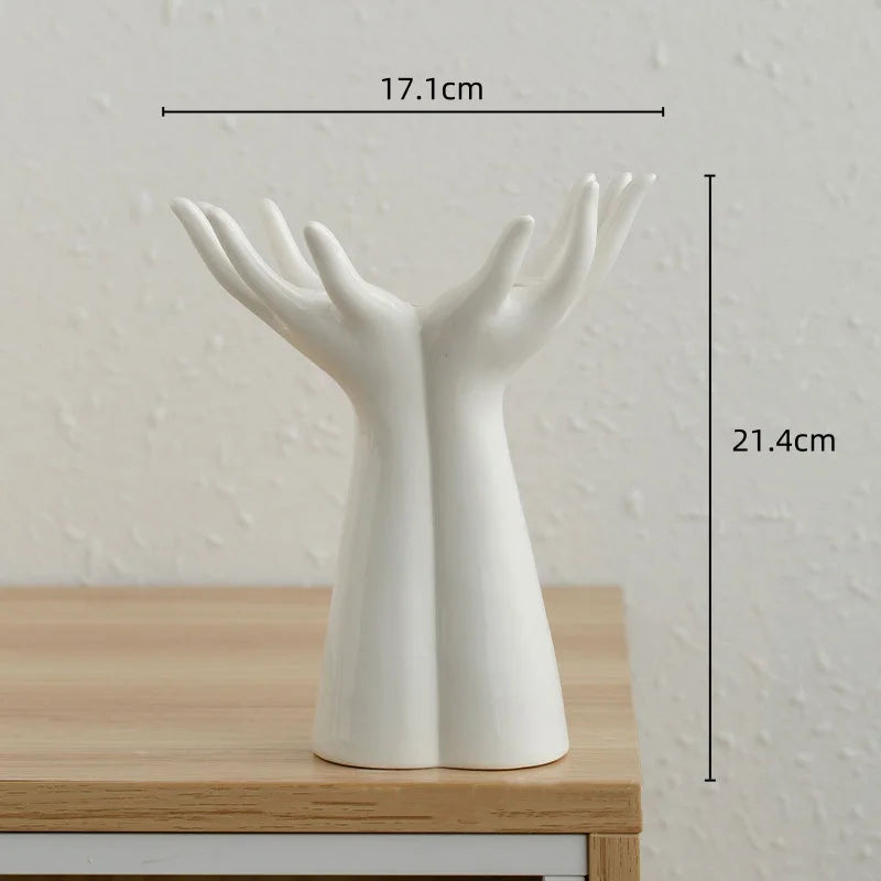 Modern ceramic vase shaped like hands, ideal for flower arrangements; porcelain handicraft for home decoration.