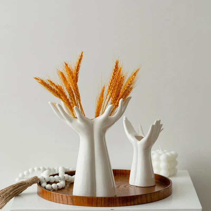 Modern ceramic vase shaped like hands, perfect for tabletop display and flower arrangements.