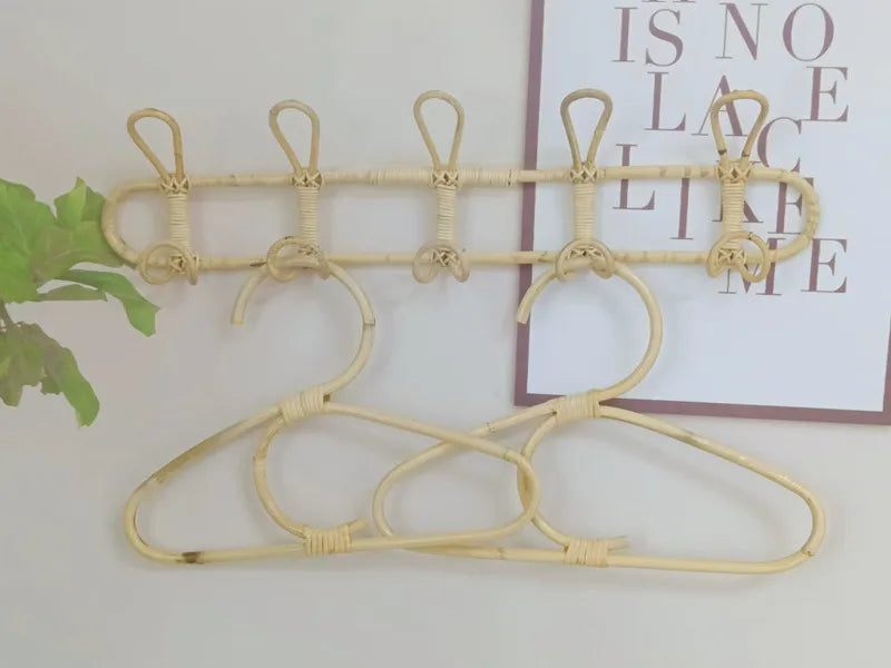 Rattan wall hooks with hangers, perfect for kids' room organization and decoration. Eco-friendly and space-saving design.