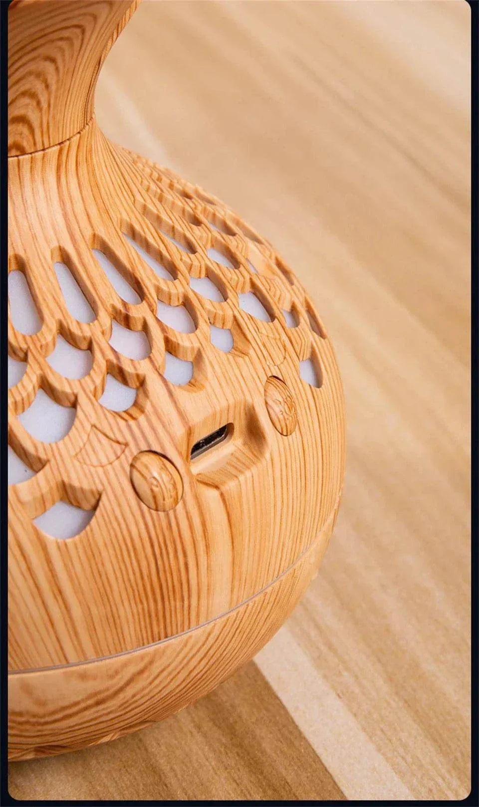Wood grain humidifier featuring USB connection and intricate design on a wooden surface.