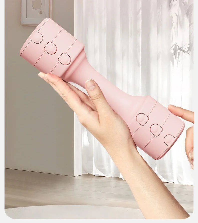 Adjustable pink rubber-covered dumbbell held in hands for strength training.
