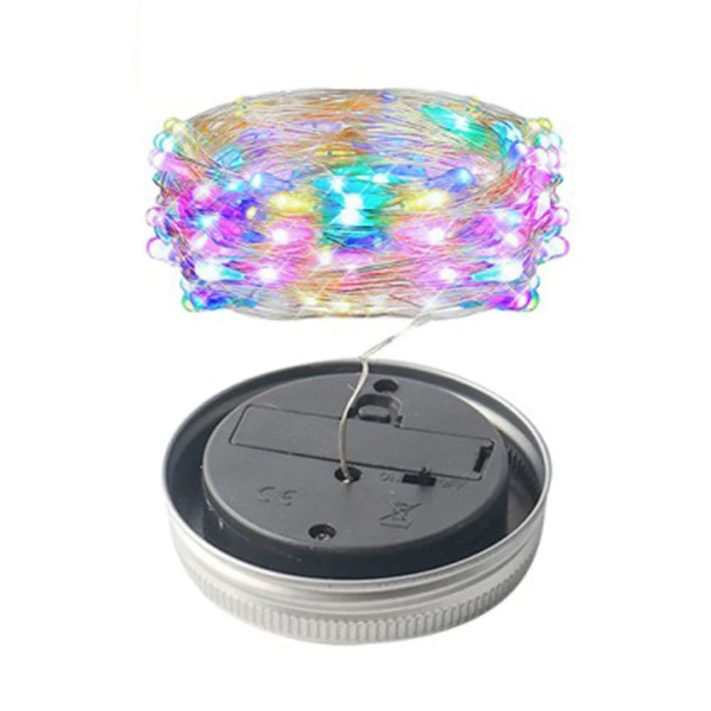Solar mason jar lights with colorful LED string and solar charging base.