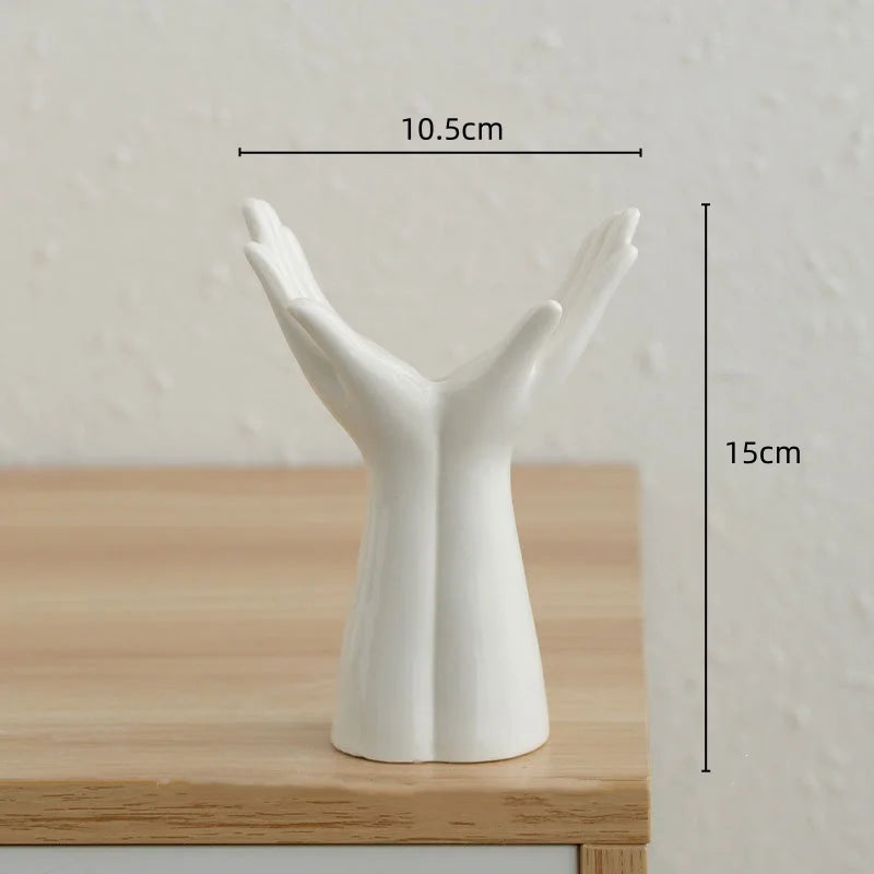 Ceramic vase shaped like hands, suitable for flower arrangements and home decoration.