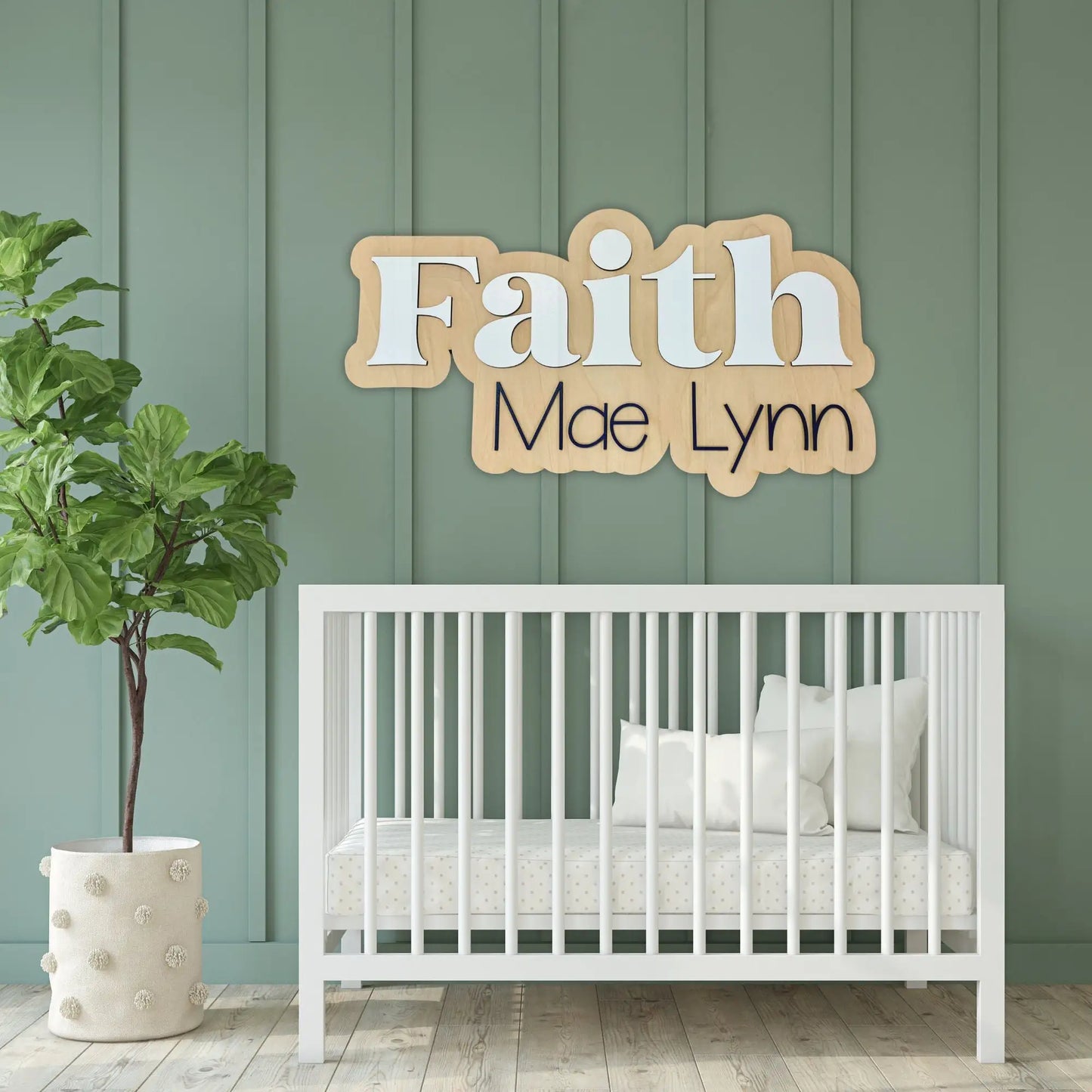 Customized wood baby name sign in nursery room above crib, personalized wall decor.