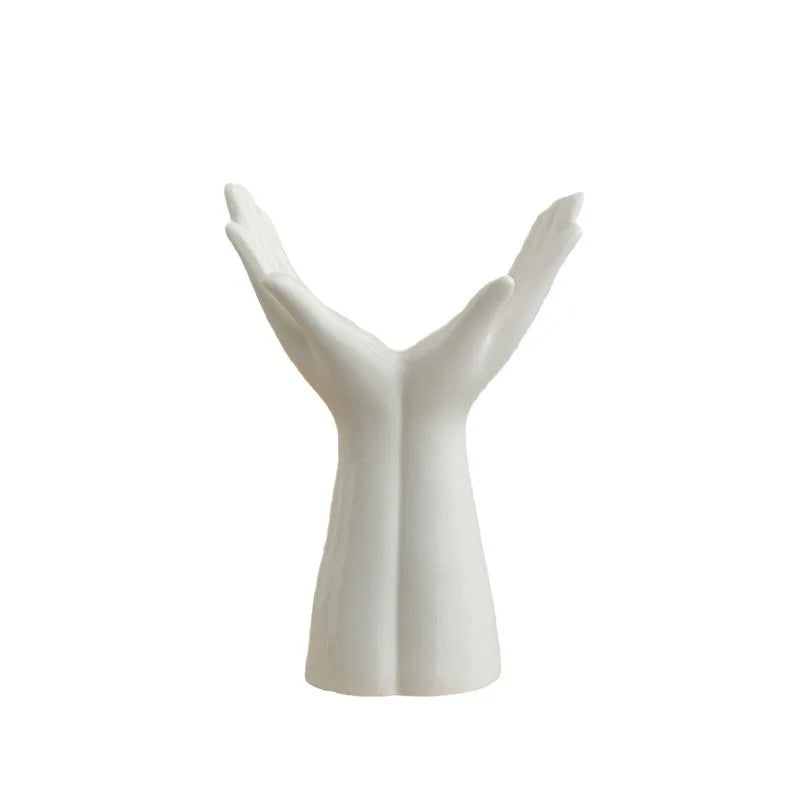 Ceramic vase with hand arm design for modern home decoration.