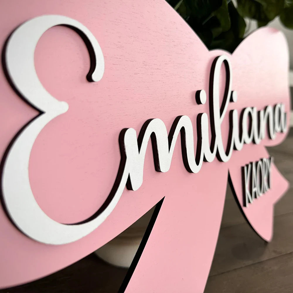 Customized pink wood baby name sign with white lettering, personalized nursery decor, perfect for baby gift.