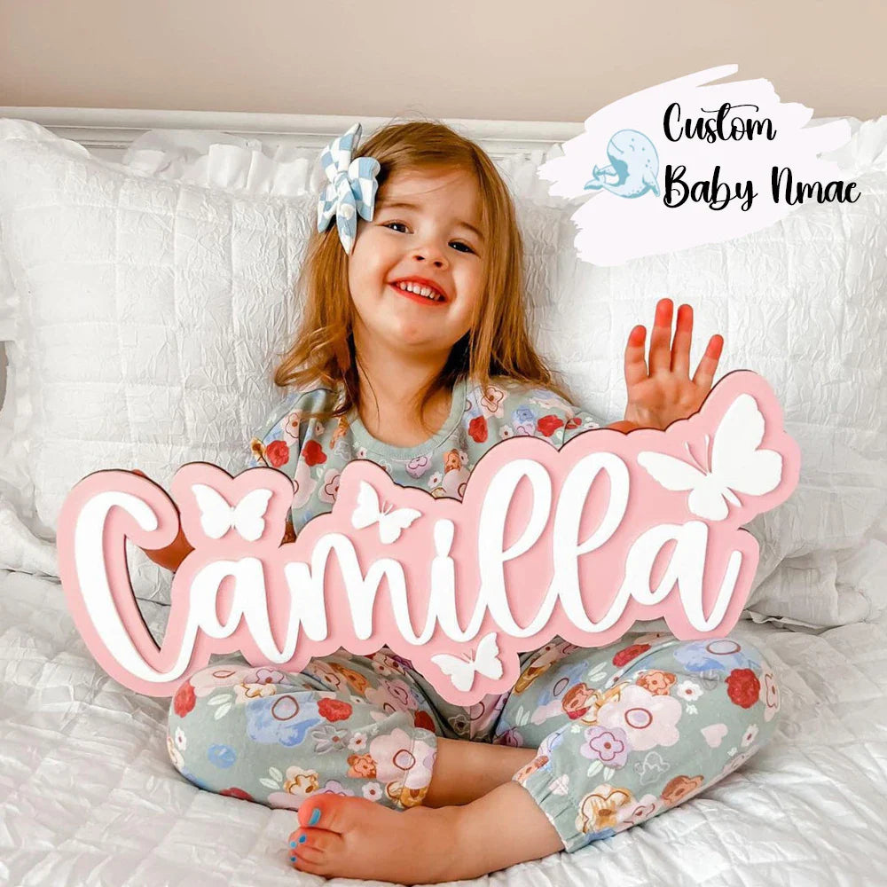 Customized wooden baby name sign with bow design, perfect for nursery wall decor and personalized baby gifts.