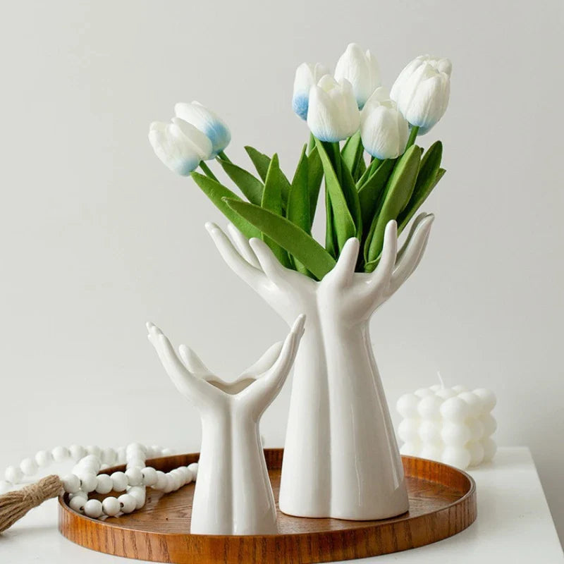 Modern ceramic vase shaped like hands holding a bouquet, ideal for tabletop decoration and home ornamentation.