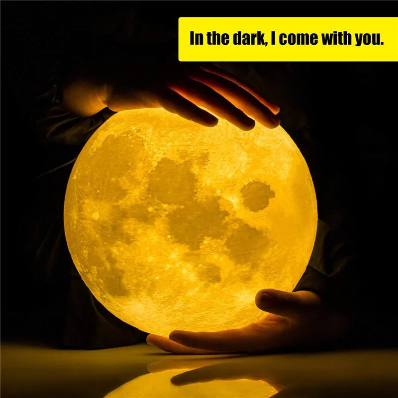 3D moon lamp with a glowing yellow LED light, held in hands for a romantic indoor decoration.