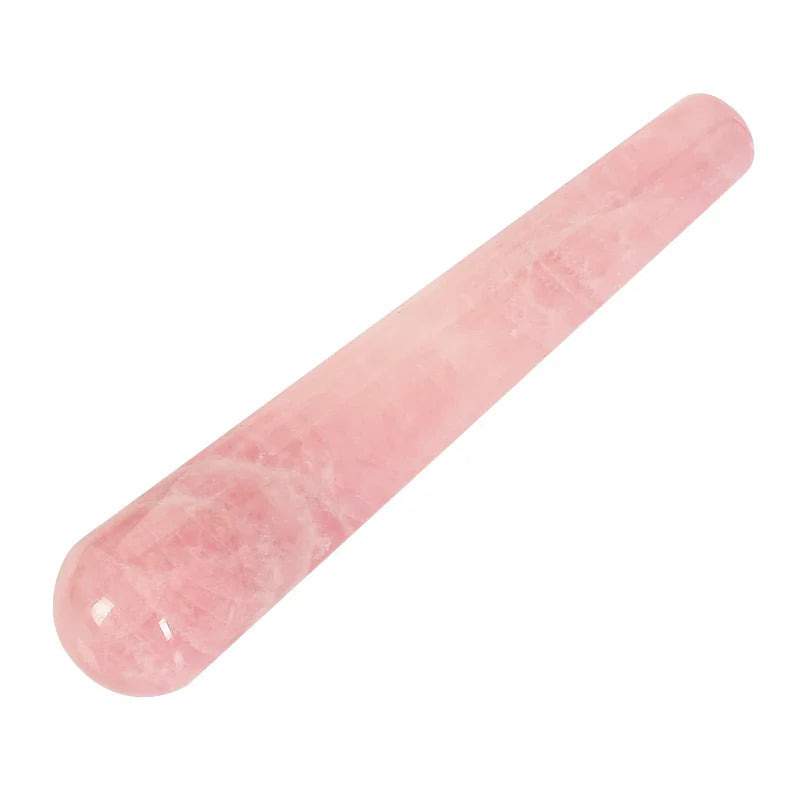 Natural rose quartz crystal face massager for skincare and relaxation.