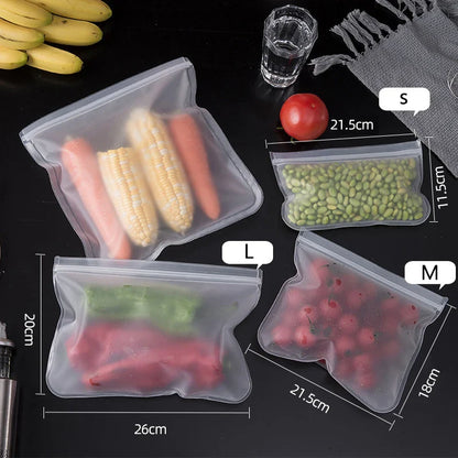 Set of reusable silicone food storage bags in small, medium, and large sizes with zip shut leakproof seals, shown filled with vegetables and fruits on a dark surface.