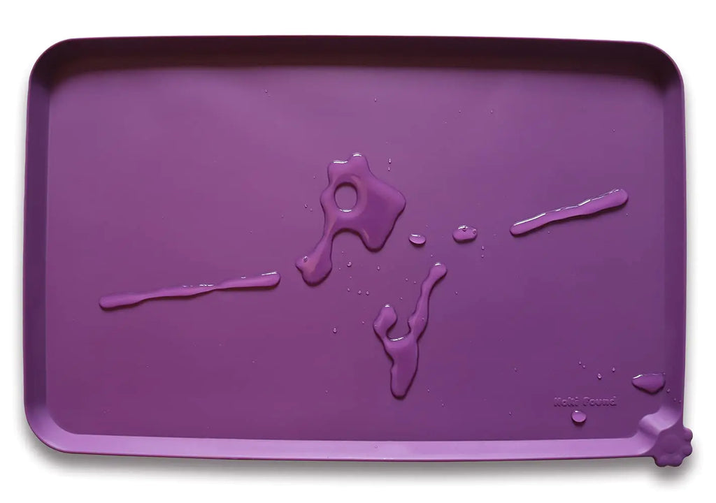 Hoki Found silicone pet food mat in eggplant purple with water droplets, non-slip and waterproof placemat for dog and cat feeding.