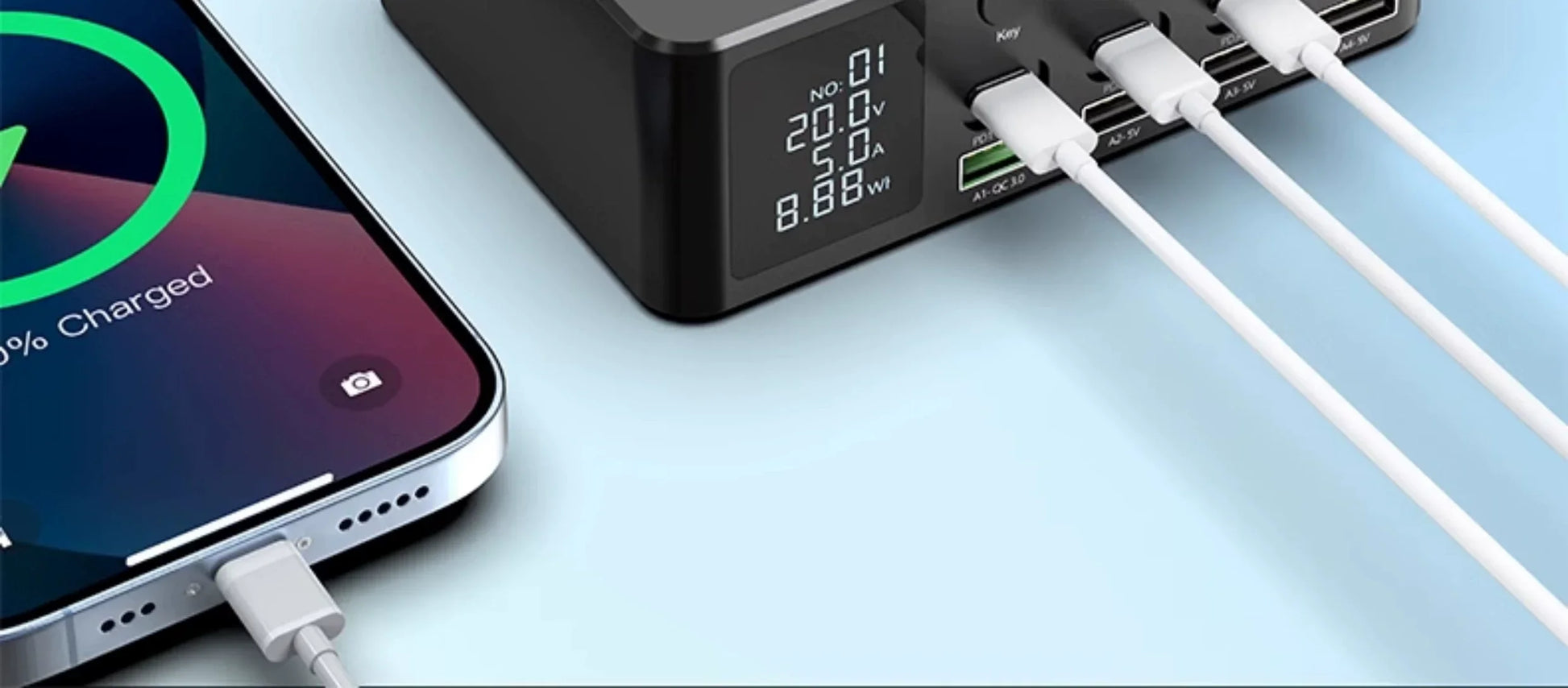 GaN fast charger with PD and USB, Type-C ports charging phone, digital display showing voltage and wattage.