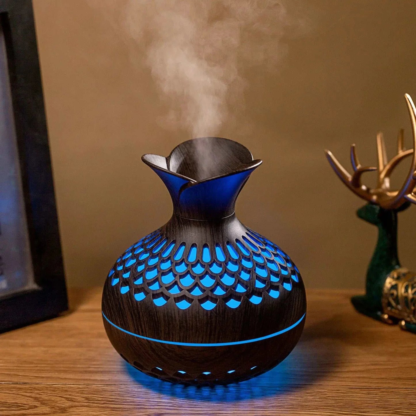 Wood grain humidifier with USB connection, emitting mist and featuring colorful LED lights, on a wooden tabletop.