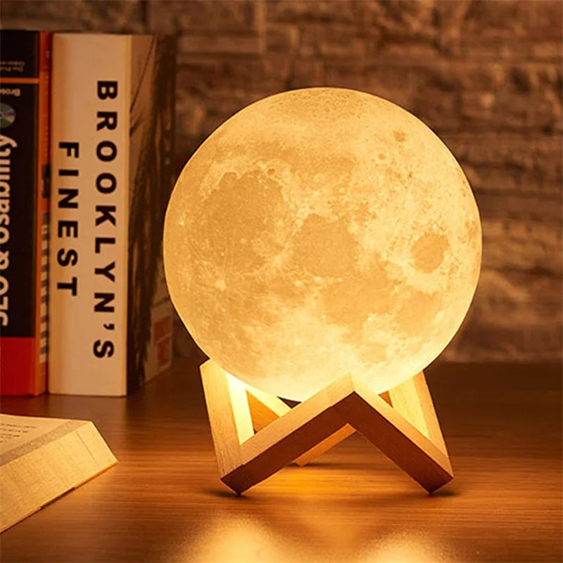 3D printed moon lamp with wooden stand, glowing on a table.