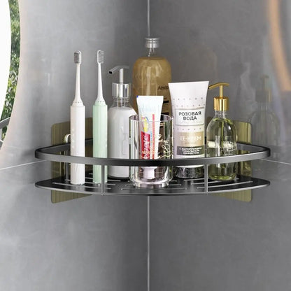 Corner-mounted no drill shower shelf for bathroom storage.