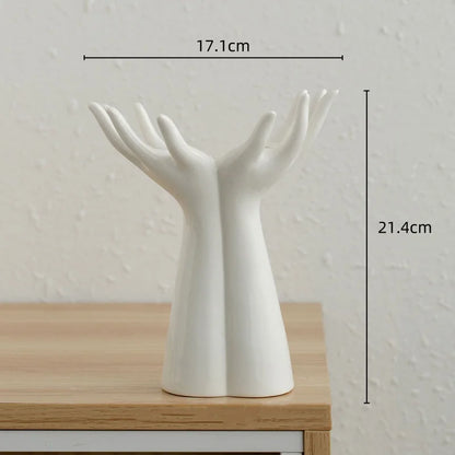 Modern ceramic vase shaped like hands, ideal for flower arrangements; porcelain handicraft for home decoration.