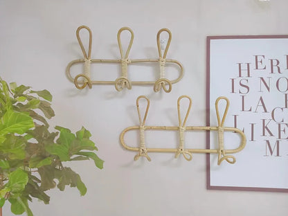 Rattan wall hooks for kids' room decor and clothing organization.