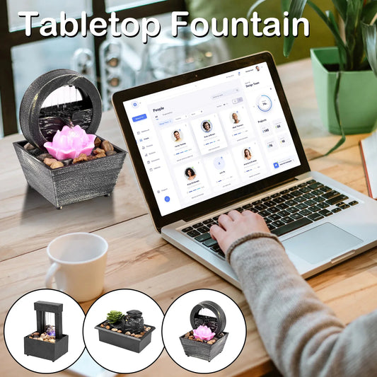 Mini tabletop fountain with light on desk, featuring a unique design with pebbles and soft lighting, ideal for relaxation and meditation.