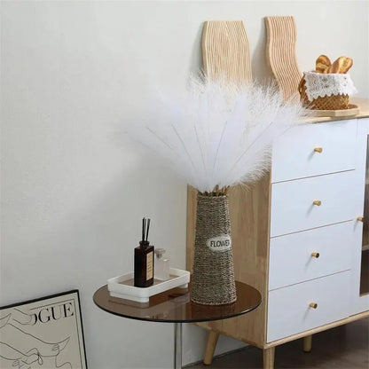 Artificial faux pampas grass in a rustic vase on a side table for home decoration.
