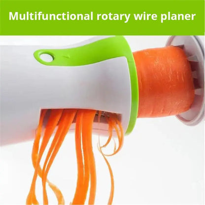 Stainless steel vegetable spiralizer slicing carrot into spirals.