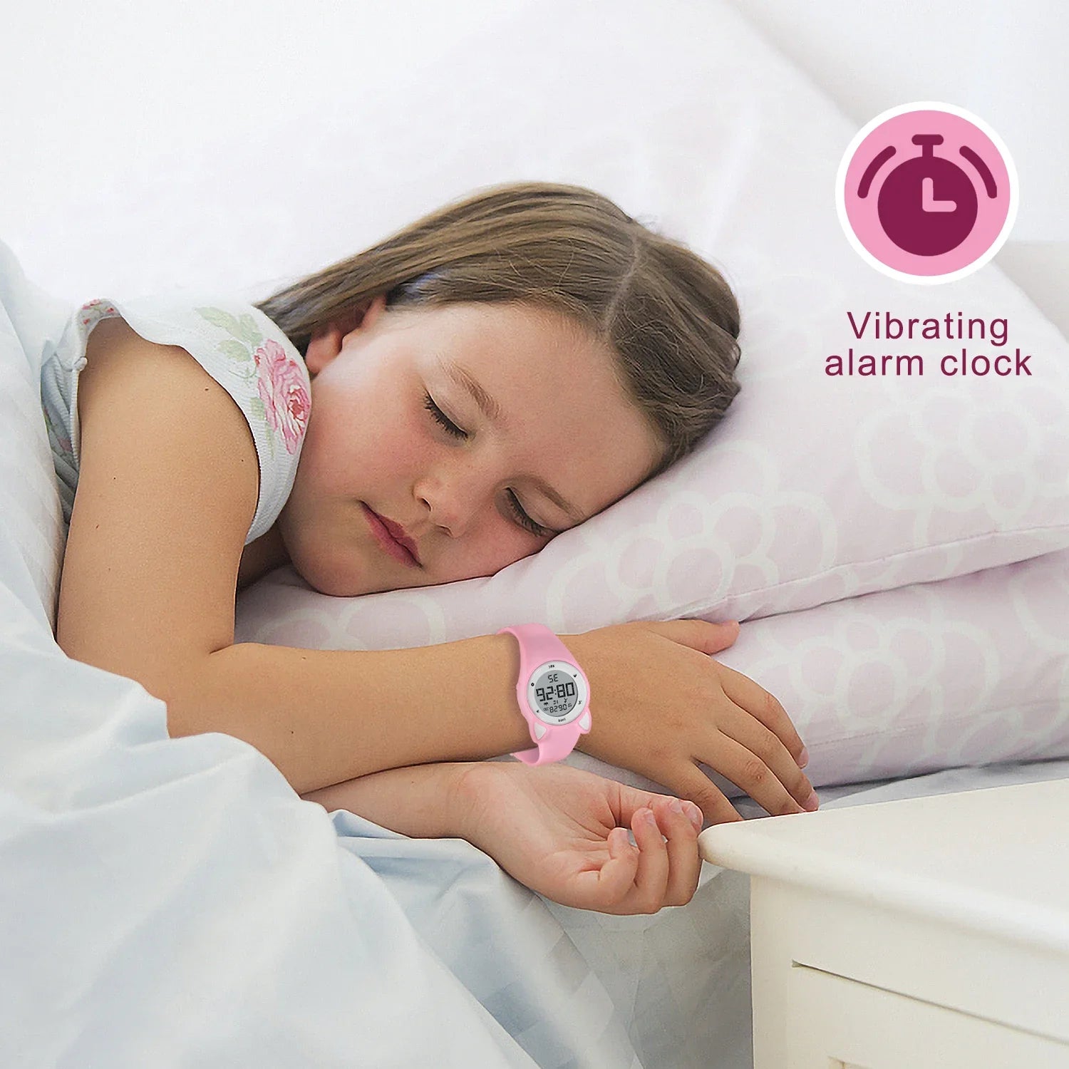 Child wearing a pink fitness tracker watch with vibrating alarm clock while sleeping.