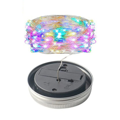 Solar mason jar lights with colorful LED string and solar charging base.