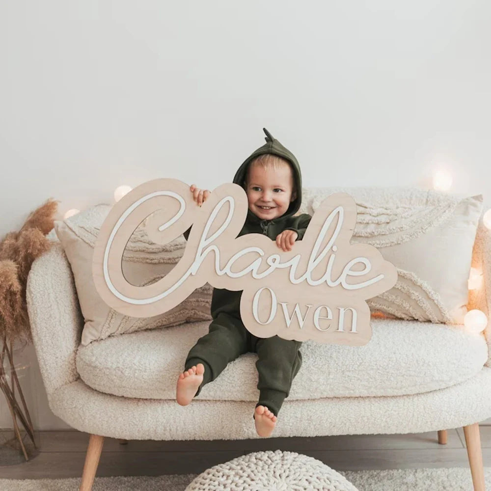 Customized wood baby name sign for nursery room decor, featuring a playful script style.