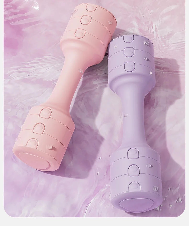 Adjustable dumbbells with a rubber cover in pink and purple colors on a reflective surface.
