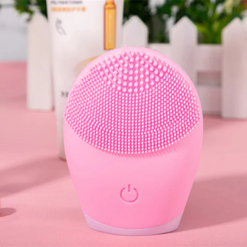 Pink electric facial cleansing brush with silicone bristles for deep cleaning and massage.