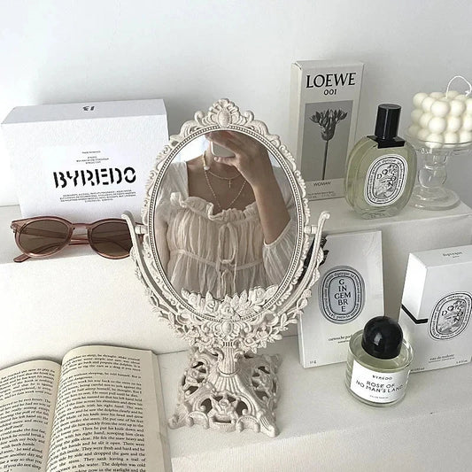 Vintage European style oval makeup mirror with 360-degree rotating swivel, decorative desktop vanity accessory.