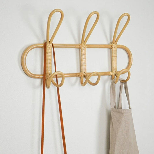 Natural rattan wall hooks with creative design for children's room, ideal for organizing clothes and accessories.