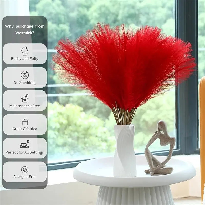 Red faux pampas grass bouquet in a white vase on indoor table, maintenance-free artificial decor.