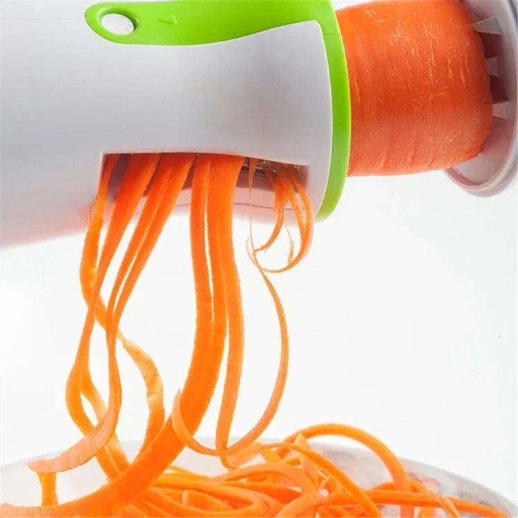 Stainless steel vegetable spiralizer slicing carrots into spirals.