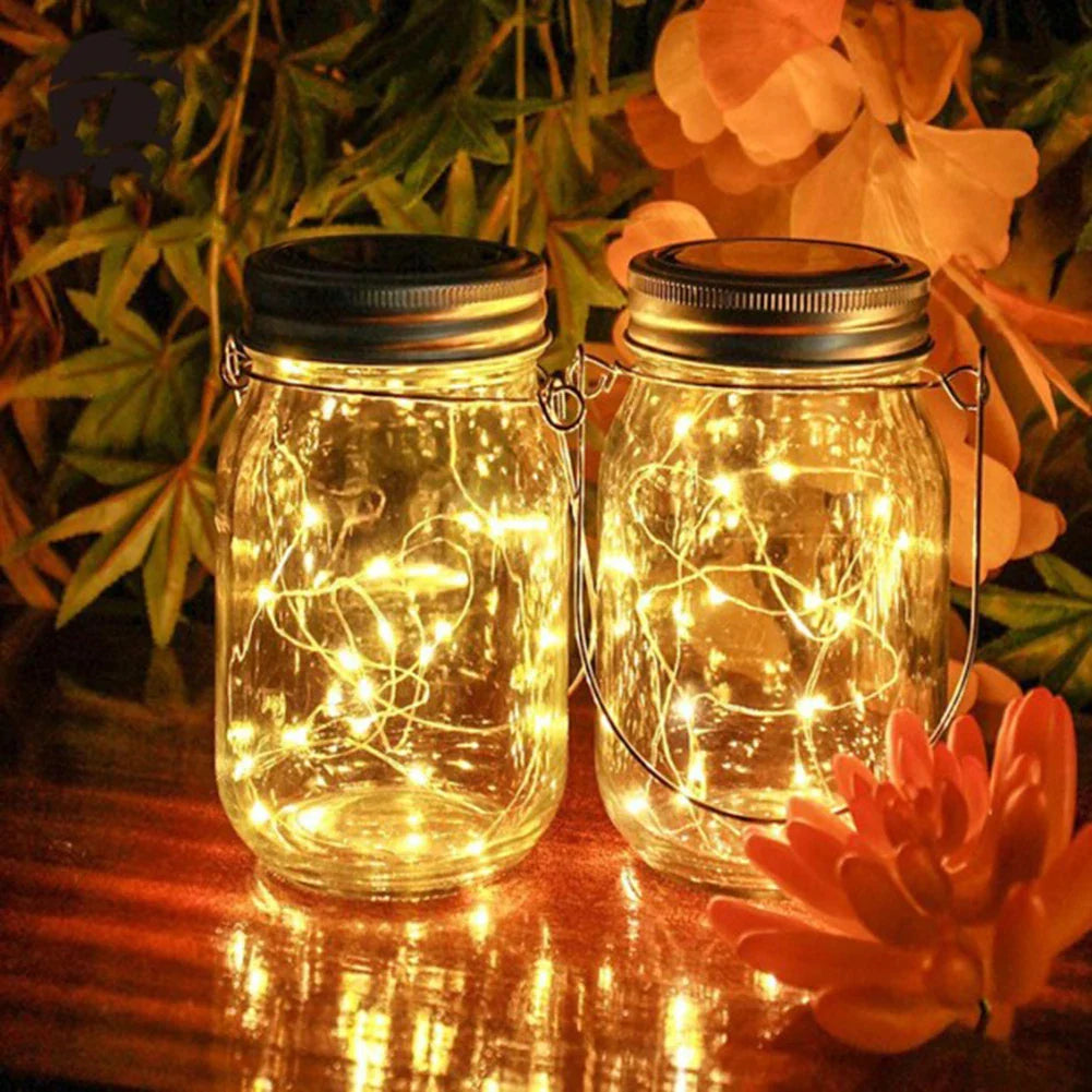 Solar mason jar lights illuminated on a table, enhancing outdoor decor with warm white LED ambience.