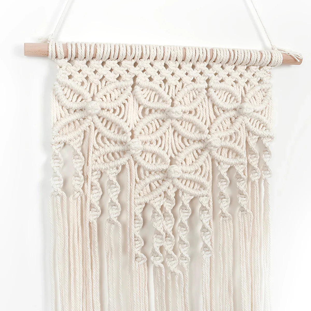 Handmade ethnic macrame wall hanging tapestry with tassels in beige, crafted from cotton and wood, ideal for home decor.