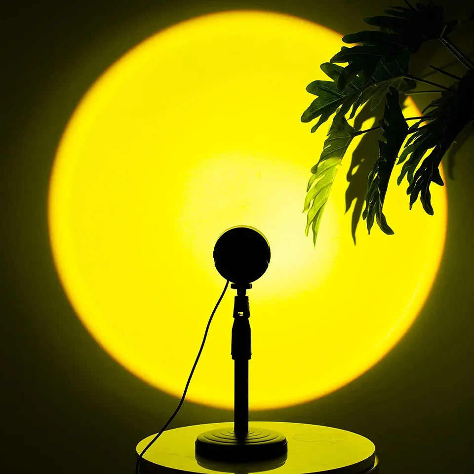 Sunset lamp projection LED light with a vibrant yellow glow, featuring 360° rotation and a silhouetted plant.