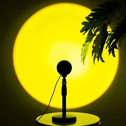 Sunset lamp projection LED light with a vibrant yellow glow, featuring 360° rotation and a silhouetted plant.