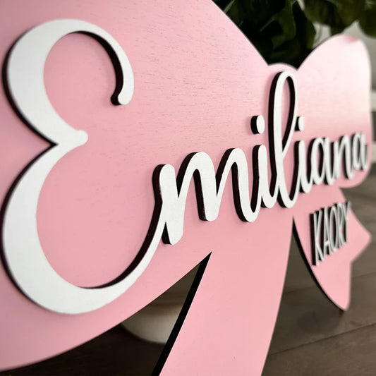 Customized pink wood baby name sign with white lettering, personalized nursery decor, perfect for baby gift.