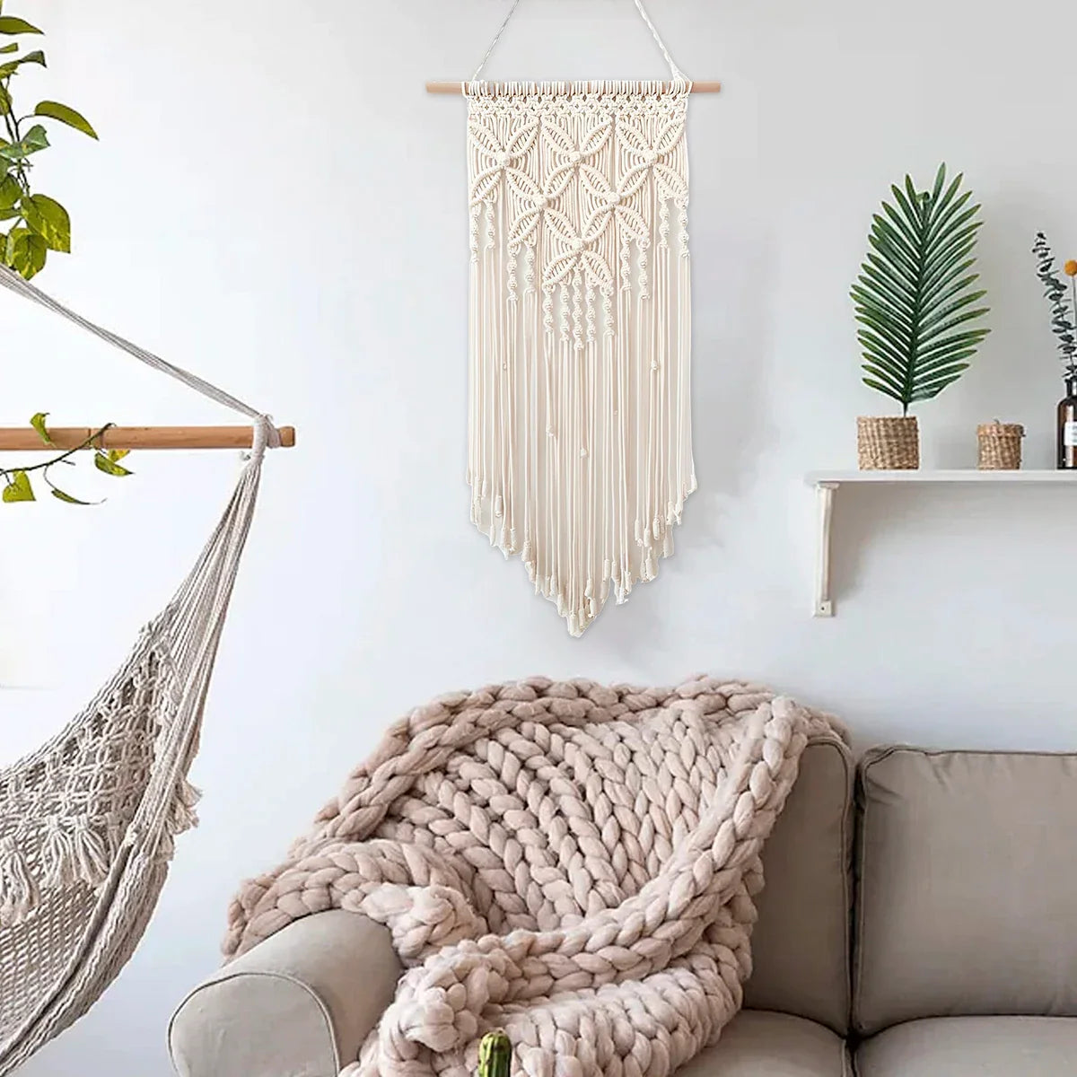 Handmade beige macrame wall hanging tapestry with tassels, ethnic woven art for home decor in living room or bedroom.