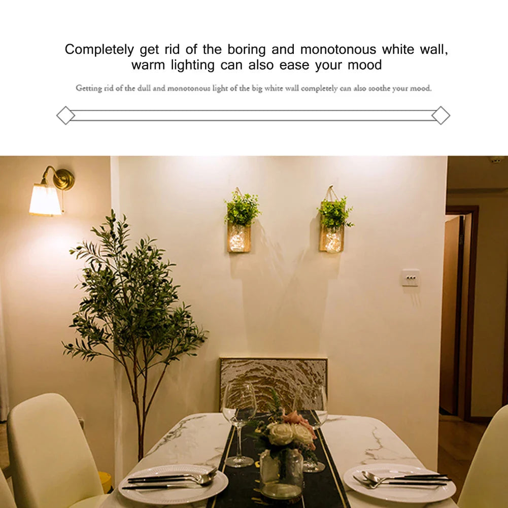 Warm-lit room with solar mason jar lights on wall above dining table, creating cozy ambiance.
