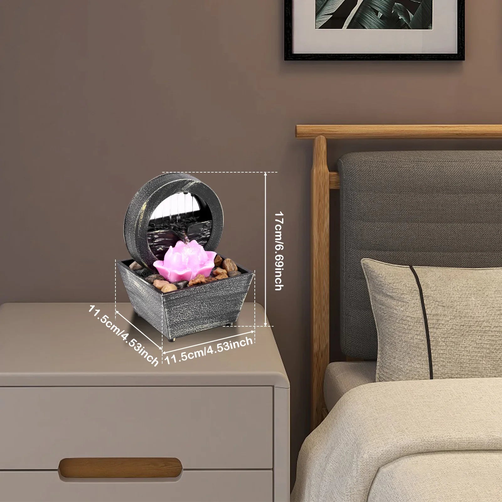Mini indoor tabletop fountain with light and pebbles on a nightstand for relaxation and meditation.