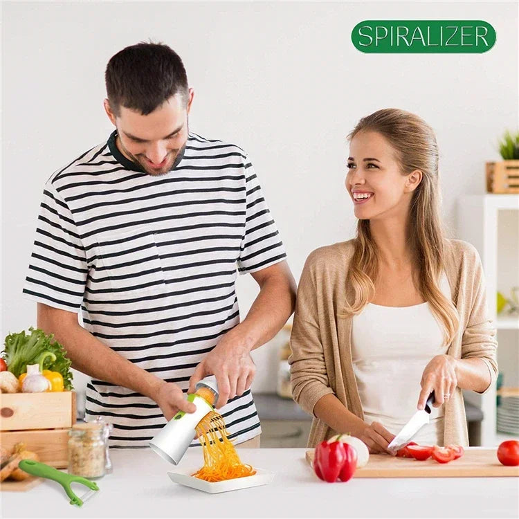 A couple using a vegetable spiralizer in a kitchen setting.