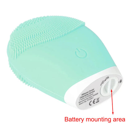 Electric facial cleansing brush with silicone bristles and battery compartment.