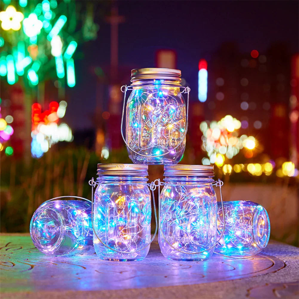 Solar mason jar lights with multicolor LEDs illuminating outdoor space at night.