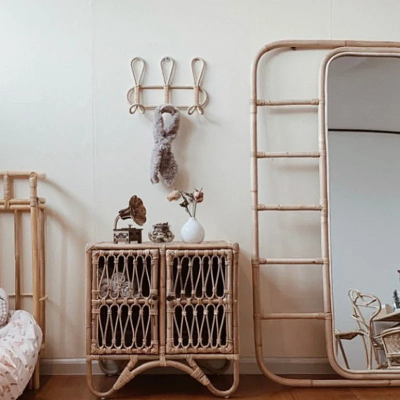 Natural rattan wall hooks for kids' room decor and organization.