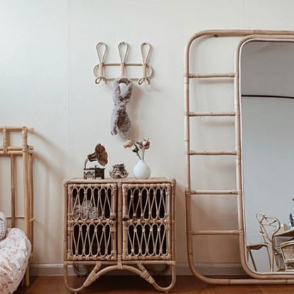 Natural rattan wall hooks for kids' room decor and organization.