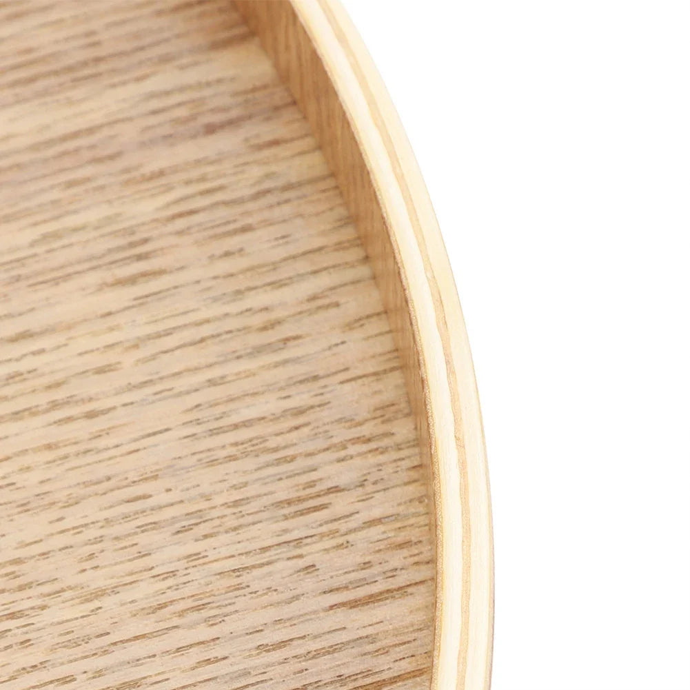 Wooden serving tray close-up showing natural grain and round edge design.